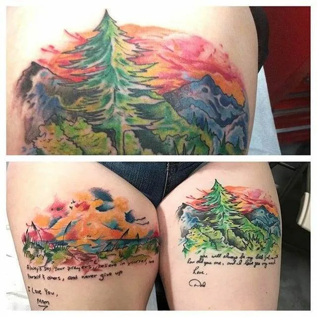 Two images showing a colorful tattoo of a woodland scene with a tree and hills. The tattoo includes handwritten text that reads, "I love you, Mom. Dad." and a message in smaller handwriting beneath it.