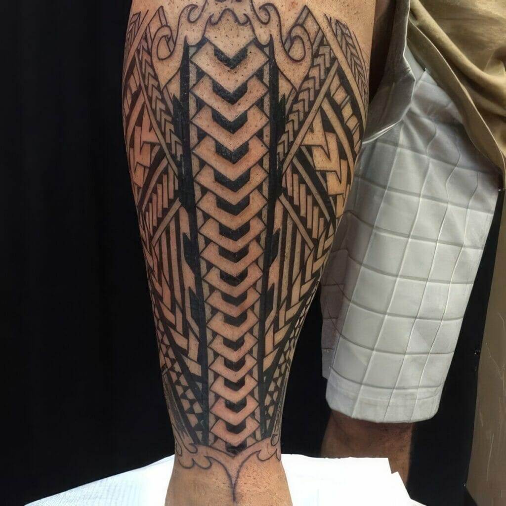 A leg tattoo featuring a geometric and tribal design pattern in black ink. The person is wearing light-colored shorts.