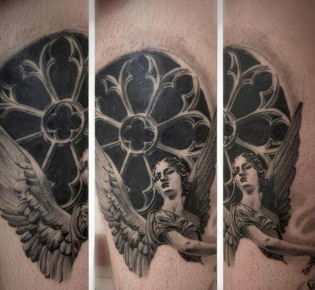 A tattoo of a winged angel with a detailed arched window behind it spans three vertical panels on a person's skin.