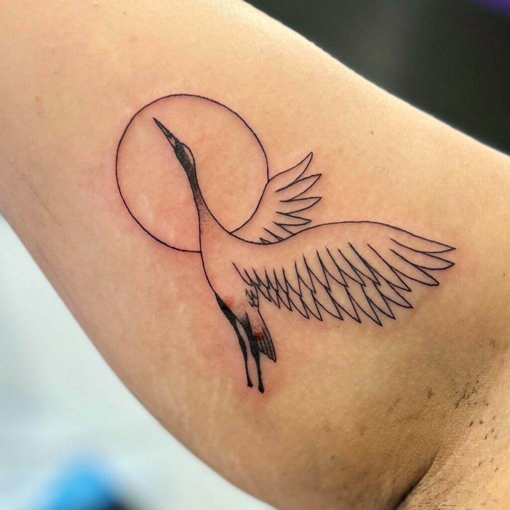 A tattoo of a bird and a circle.