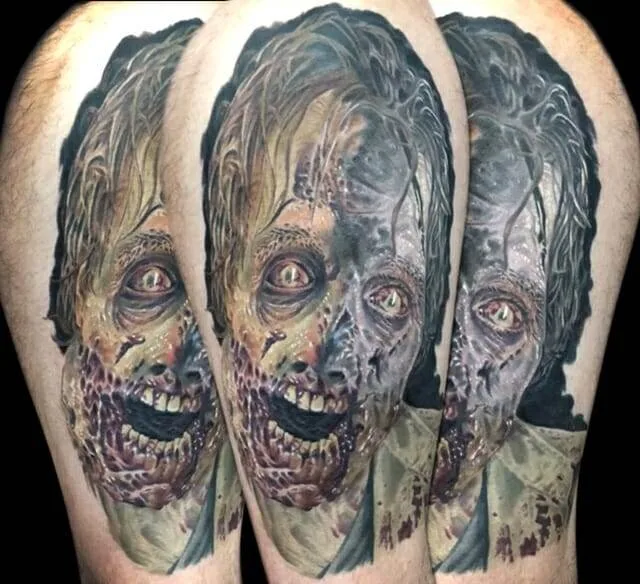 A tattoo of a decaying zombie face with detailed features, including missing teeth, exposed skin, and visible wounds.
