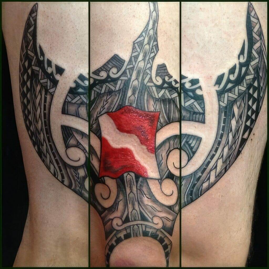 A detailed back tattoo features intricate tribal designs with a prominent red and white shield in the center.