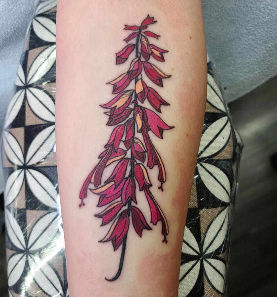 A forearm tattoo depicting a stylized plant with multiple shades of red leaves. The tattoo is freshly done and the skin appears slightly red.