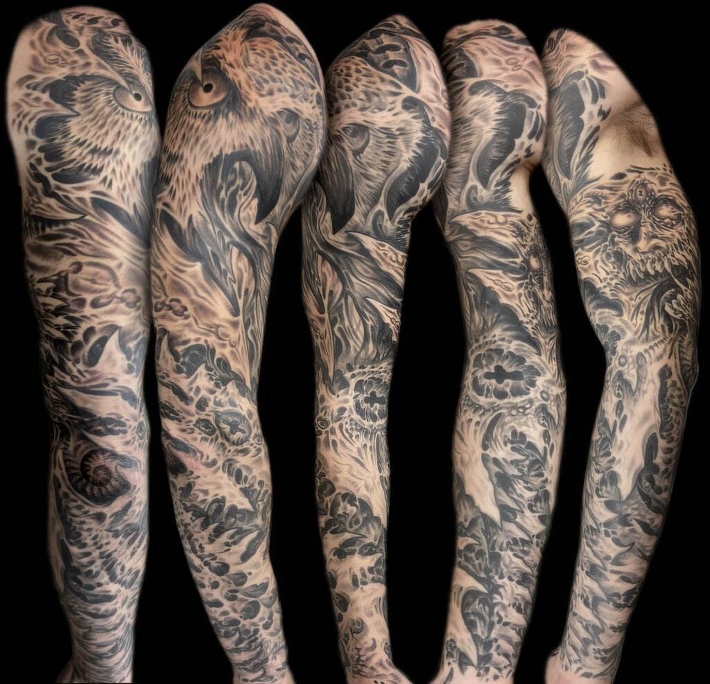 Detailed black and grey full-sleeve tattoos showcasing various intricate designs, including a prominent owl motif, extending from shoulder to wrist, on five different arms.