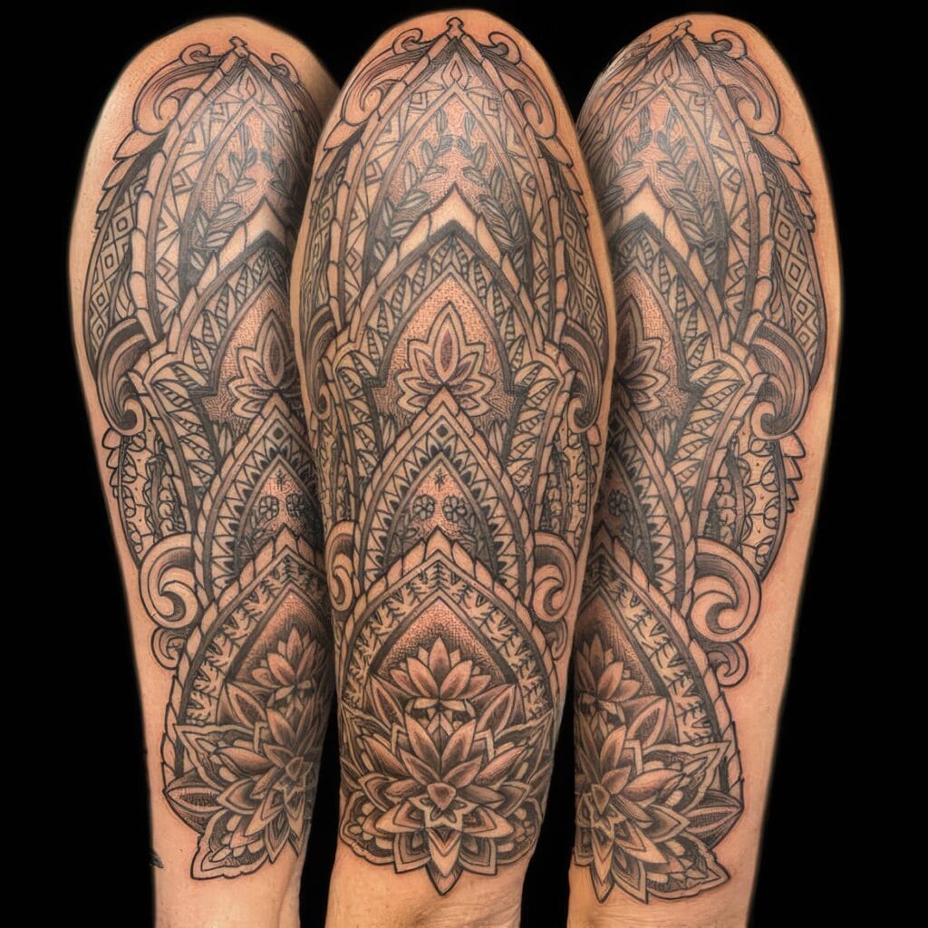 Three arms with intricate, symmetrical, black and grey mandala tattoos covering the length of the arms, photographed against a black background.