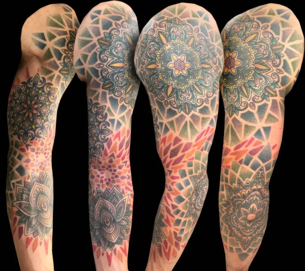 Colorful geometric and floral tattoo sleeve designs on four arms against a black background.