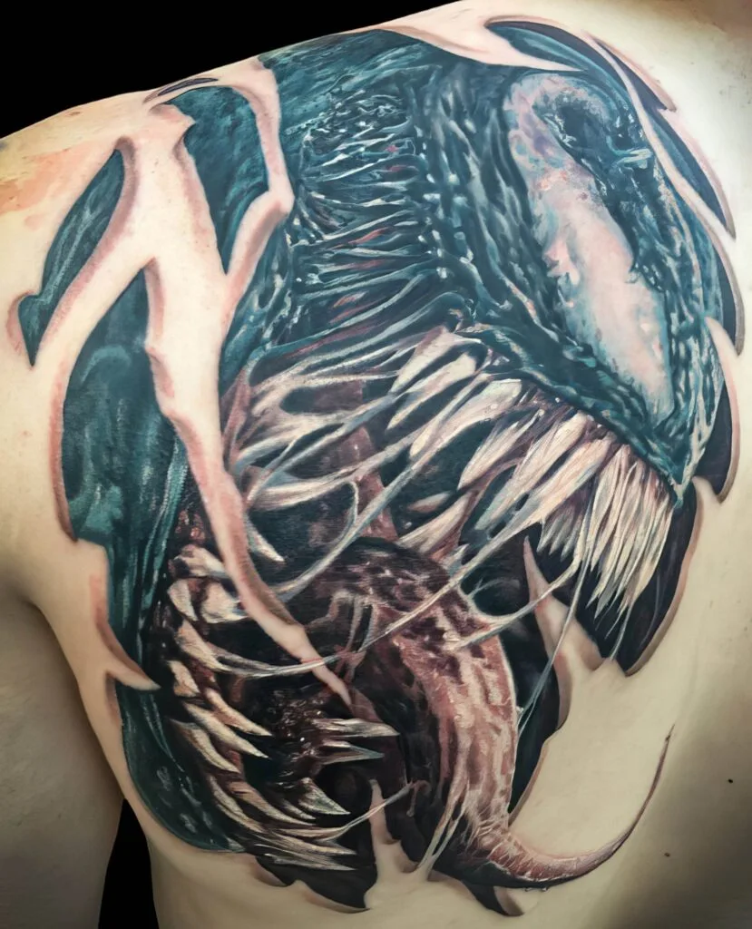 Detailed tattoo of a dinosaur skull with sharp teeth and intricate shading on the shoulder.