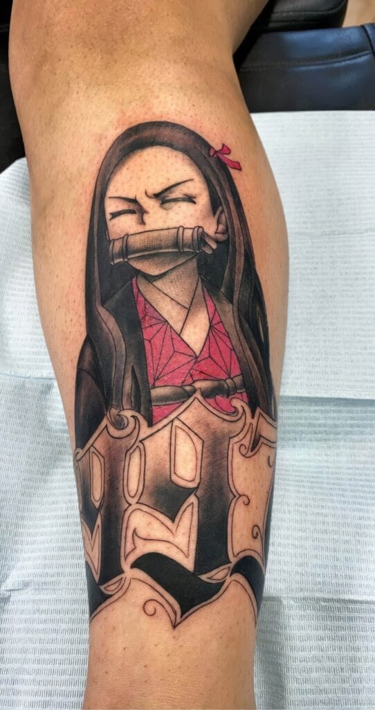 A detailed tattoo on a person's leg features a character with long hair and a bamboo gag in their mouth, surrounded by stylized designs.
