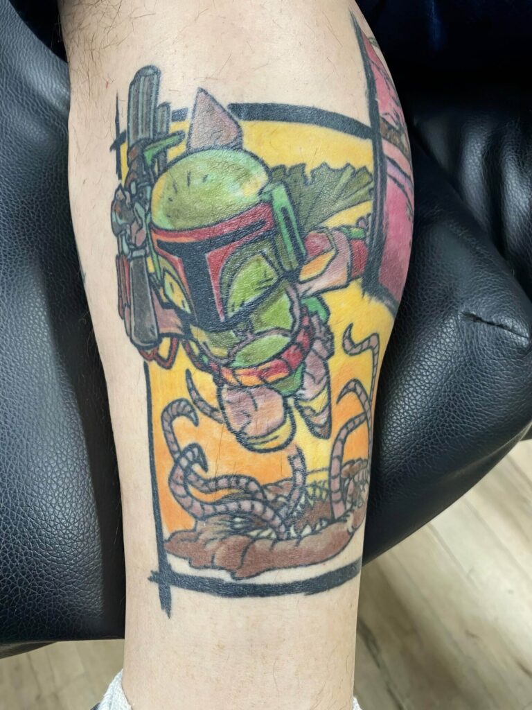 A tattoo of Boba Fett, a character from Star Wars, holding a weapon and hovering over a Sarlacc pit.