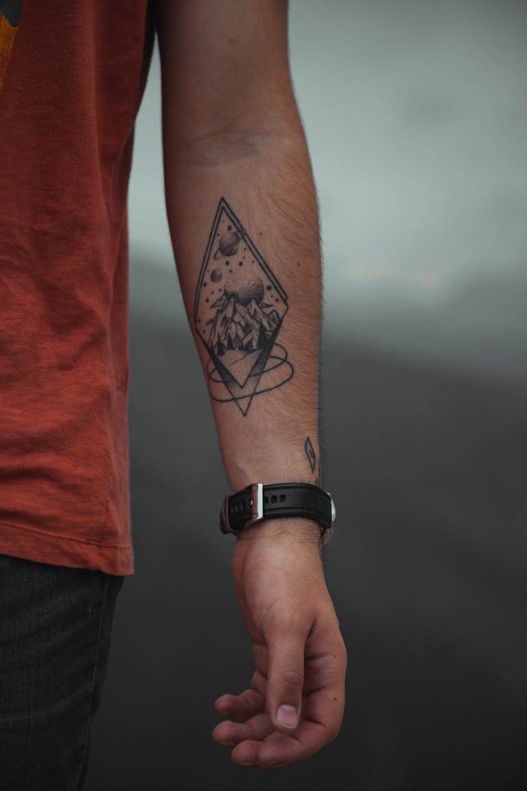 Unrecognizable man with tattoo on arm