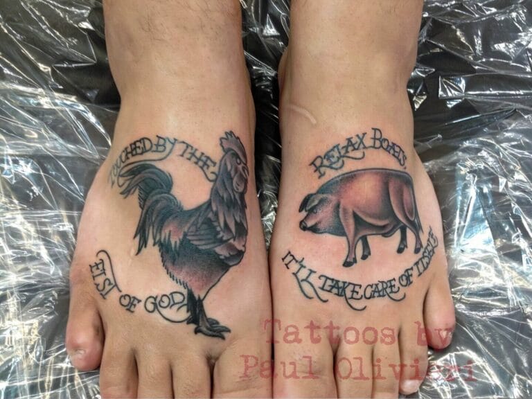 Image of two feet with tattoos. The left foot has a rooster and the text "Watched by the eye of God," while the right foot has a pig and the text "Relax boy, I'll take care of this.