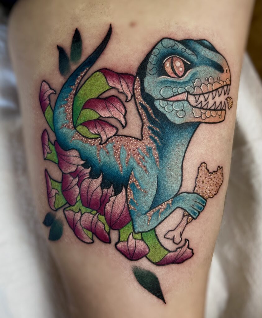 Colorful dinosaur with pink flowers and green leaves surrounding it.